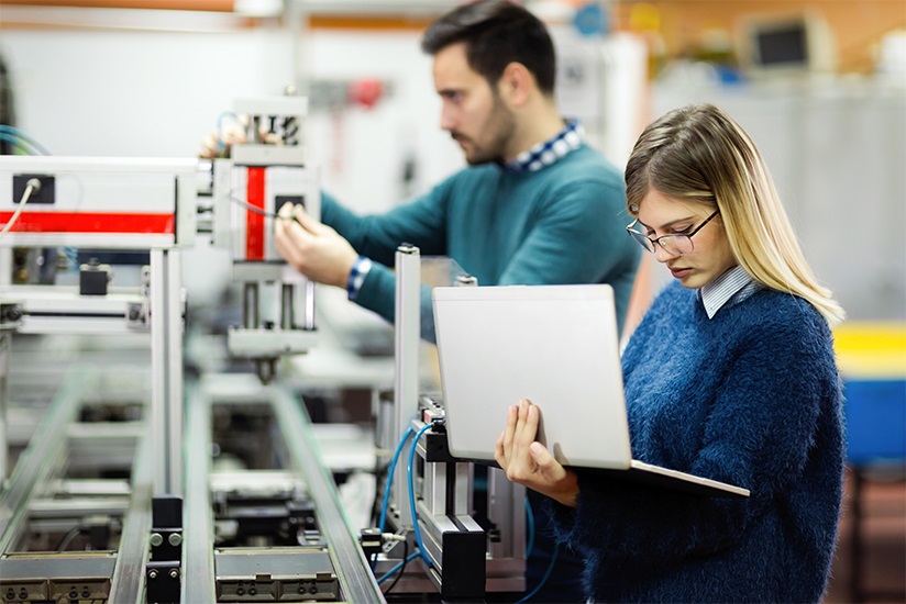 Engineers reviewing data on a factory floor